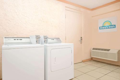 a laundry room with a washer and a dryer at Days Inn by Wyndham Independence in Independence