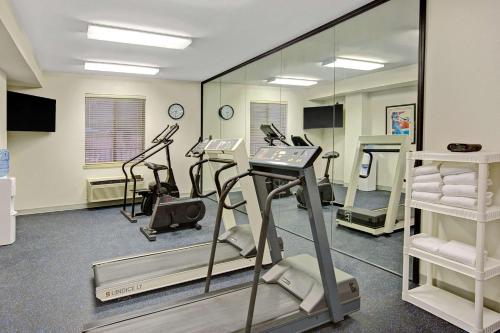 a gym with treadmills and ellipticals in a room at Days Inn & Suites by Wyndham Hickory in Hickory