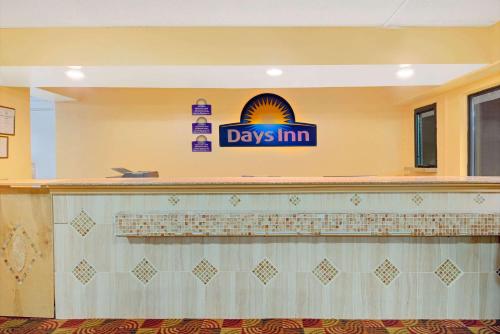 a day inn sign on the counter of a restaurant at Days Inn by Wyndham Independence in Independence