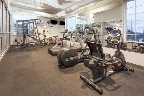 a gym with several treadmills and exercise bikes at Days Inn by Wyndham Pentwater in Pentwater