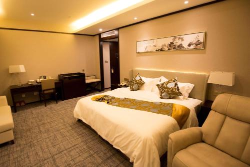 een hotelkamer met 2 bedden en een stoel bij Days Inn Hotel Wuhu Anqi in Wuhu