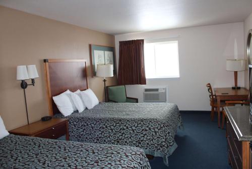 a hotel room with two beds and a window at Days Inn by Wyndham Ritzville in Ritzville