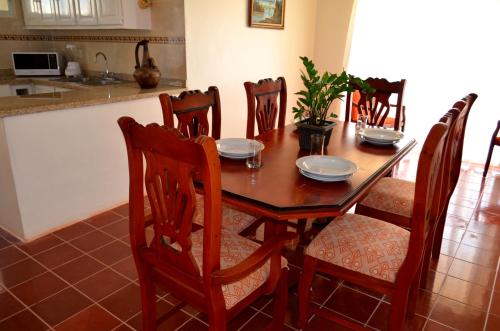 a dining room table and chairs in a kitchen at Sosua Sweet Vacations in Sosúa