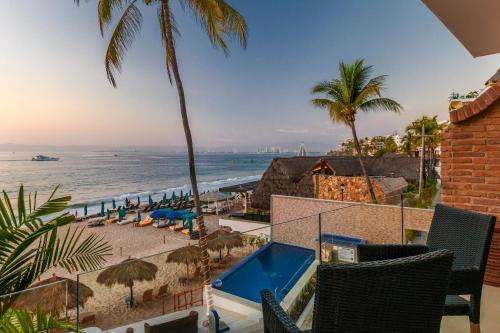 a view of the beach from the balcony of a resort at Vallarta Shores Beach Hotel in Puerto Vallarta