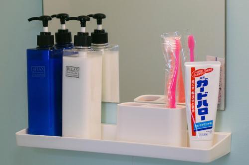 a shelf with toothpaste and toothbrushes and toothpaste at A&B Omoromachi Station in Naha
