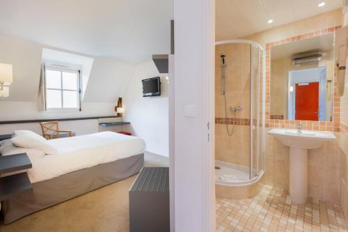a bedroom with a bed and a shower and a sink at Hotel Restaurant Le Dauphin et Le Spa du Prieuré in Caen