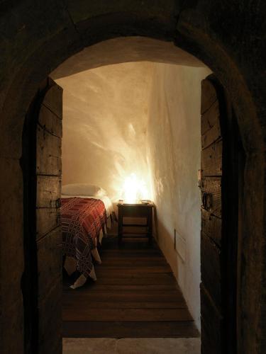a bedroom with a bed and a lamp on a table at Sextantio Albergo Diffuso in Santo Stefano di Sessanio