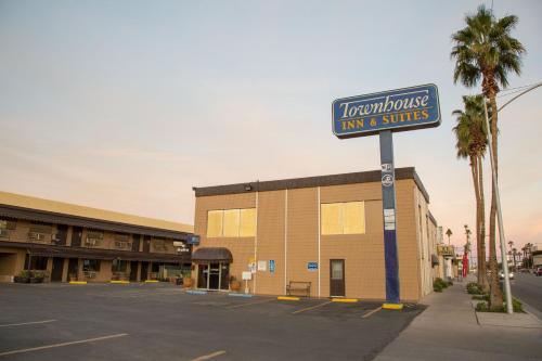 a sign for a inn and suites in a parking lot at Townhouse Inn and Suites in Brawley