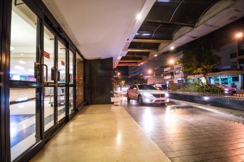 a car parked outside of a store on a city street at Hotel Faranda Express Soloy and Casino, a member of Radisson Individuals in Panama City