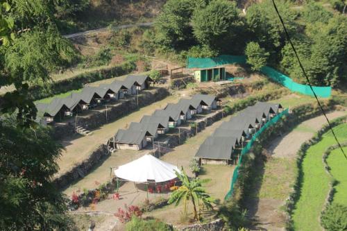 an aerial view of a resort with tents and a river at Natural Camps with InHouse Swimming Pool in Rishīkesh