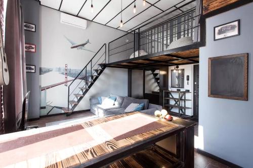 a living room with a loft with a staircase at Apartment Odessa for 4. in Odesa