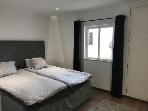 a bedroom with two beds and a window at Beach Villa Vale do Lobo in Vale do Lobo