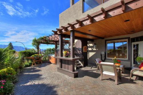 a patio of a house with a pergola at Cheers B&B in West Kelowna