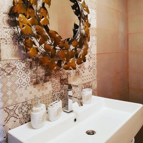 a bathroom with a white sink and a mirror at Sunshine Court in St Paul's Bay