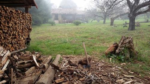 a pile of wood on the ground next to a house at La Tierra Grande in Zacatlán