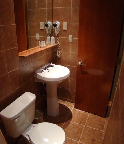 a bathroom with a toilet and a sink at Belnord Hotel in New York