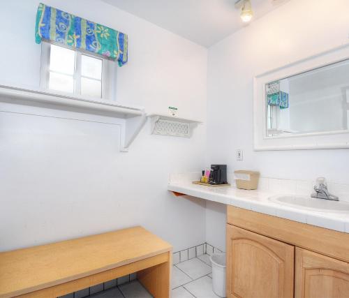 a white bathroom with a sink and a window at Morro Bay Sandpiper Inn in Morro Bay