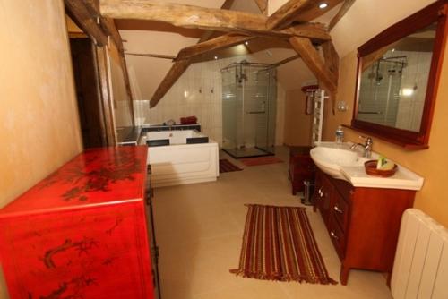a large bathroom with a red refrigerator and a sink at Château de Belle Poule in Les Ponts-de-Cé