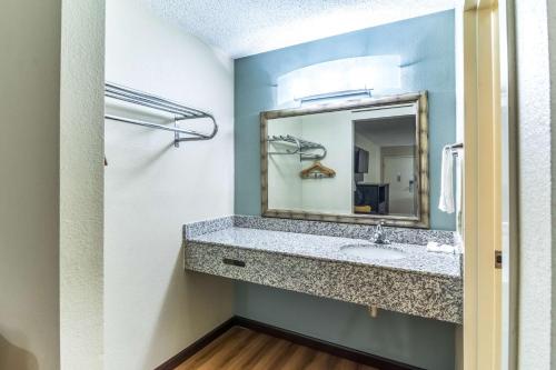 a bathroom with a sink and a mirror at Motel 6-Kenly, NC in Kenly
