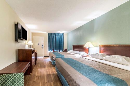 a hotel room with two beds and a television at Motel 6-Kenly, NC in Kenly
