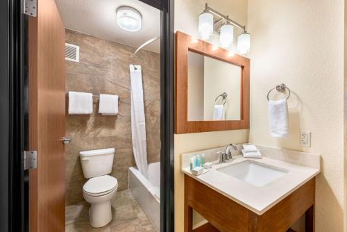a bathroom with a sink and a toilet and a mirror at Ellis Island Hotel Casino & Brewery in Las Vegas