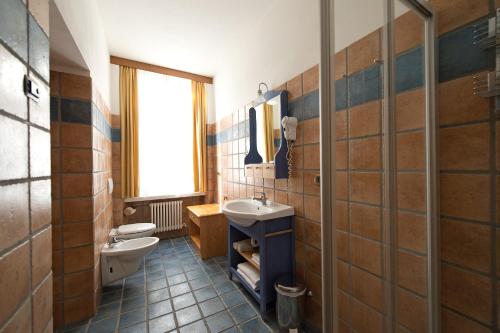 a bathroom with a sink and a toilet and a window at Residence Villa Nicole in Arco