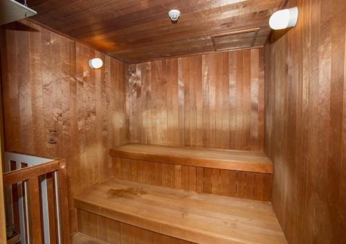 a sauna with wooden walls and a wooden floor at Hotel New Momiji in Nasushiobara