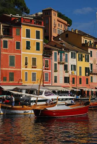 a group of boats in the water in front of buildings at Hotel Miro' in Rapallo