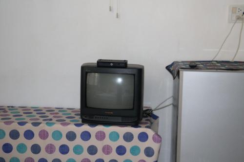 a small television sitting on top of a bed at J Home apartment Hadyai in Hat Yai