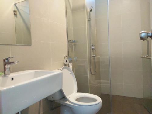 a bathroom with a toilet and a sink and a shower at Atlantis Residence Melaka in Melaka