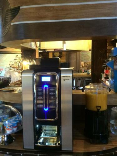 a coffee maker sitting on a counter with a drink at Hotel Nuit Et Jour - La Maison de Lucile in Cancale