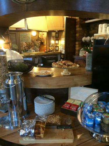 a kitchen with a counter with food on a table at Hotel Nuit Et Jour - La Maison de Lucile in Cancale