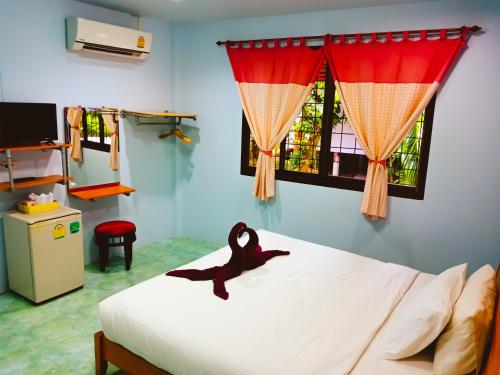 Ban Tai Resort في بان تاي: وجود حوريه تجلس على سرير في غرفه