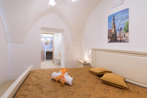 a bedroom with a bed with a bow on it at Le Volte in Sannicola