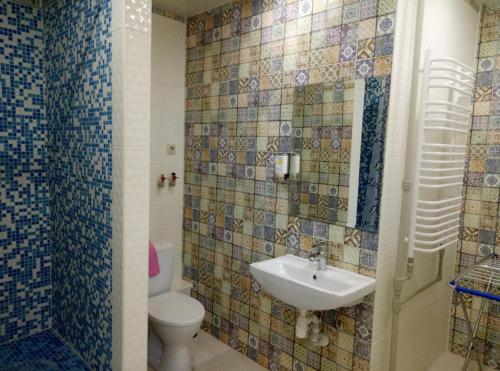a bathroom with a toilet and a sink at Hostel Svit Hub in Kamianets-Podilskyi