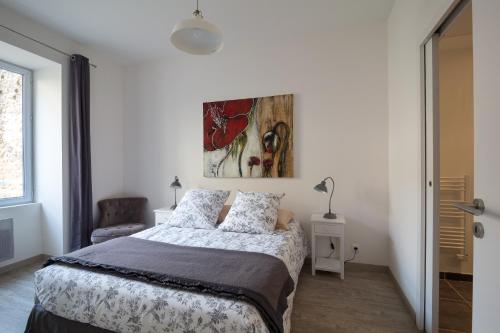 a bedroom with a bed and a painting on the wall at Bordeaux Village Blaye in Blaye