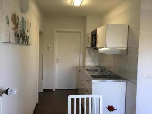a kitchen with a sink and a counter top at Ferienwohnung Villa Josephine in Badenweiler