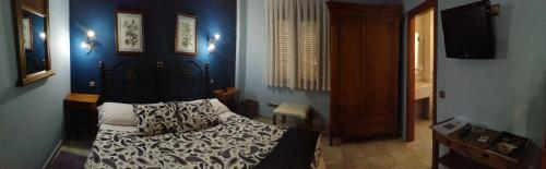 a bedroom with a bed and a blue wall at Posada Del Camino Real in Torrelaguna