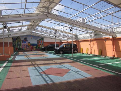 a parking lot with a car parked in a garage at Hotel Essor (Adult Only) in Nara