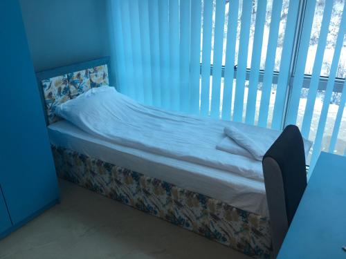 a bed in a room with a window at B&B Hisar International in Prijepolje