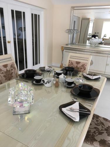 a dining room with a table with black dishes on it at Deneview in Consett