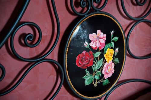 a mirror with flowers on it on a red wall at Agriturismo Il Granaio Hotel & SPA in Modica