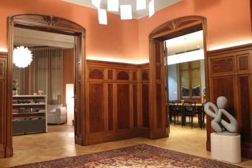a living room with a mirror and a dining room at Villa Élyane in Colmar