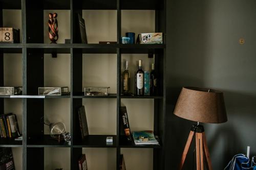 a book shelf filled with bottles and a lamp at Babaneuris Marani in Babaneuri