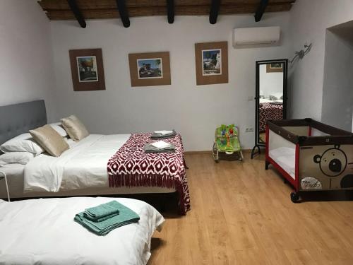 a bedroom with two beds and a mirror at Varanski Vista in San Miguel de Abona