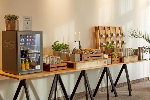 a table with a refrigerator on top of it at H4 Hotel Leipzig in Leipzig
