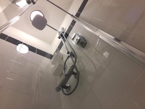 a bathroom with a shower with a shower head at Romantic Tiny House inside Montmartre in Paris