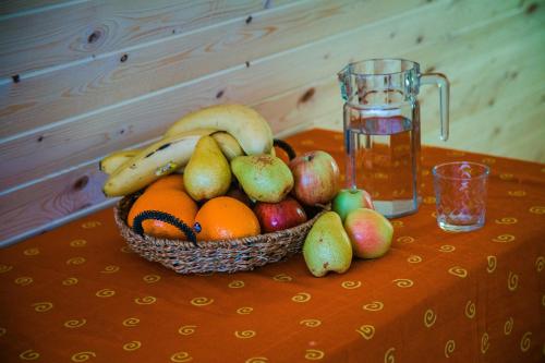 a basket of fruit on a table with a glass of water at Dunaiskaya Usadba in Vylkove