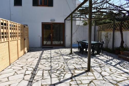 a patio with a table and a fence at Sofia Mare in San Felice Circeo