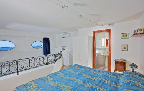 a bedroom with a bed with a blue blanket at Casetta Arienzo in Positano